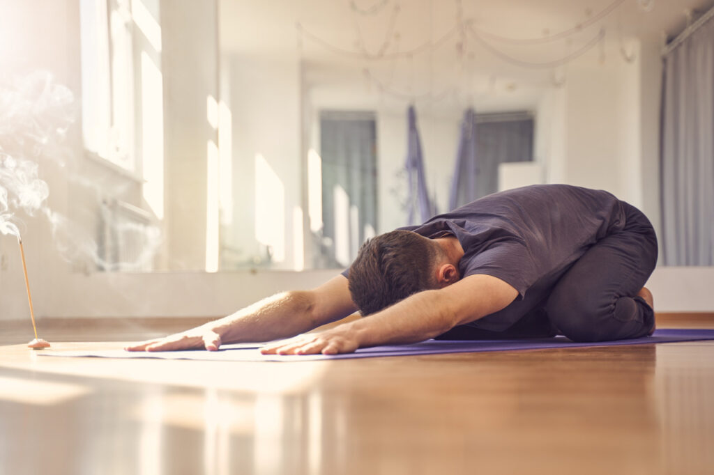 man-stretching-on-yoga-mat