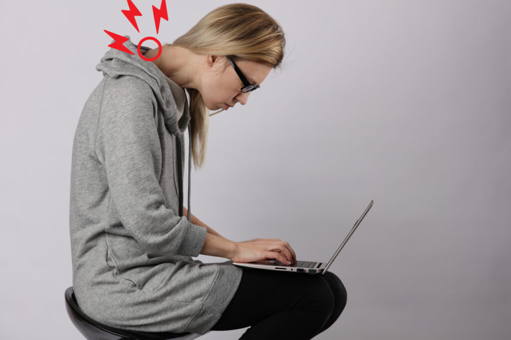 woman-straining-neck-looking-at-laptop